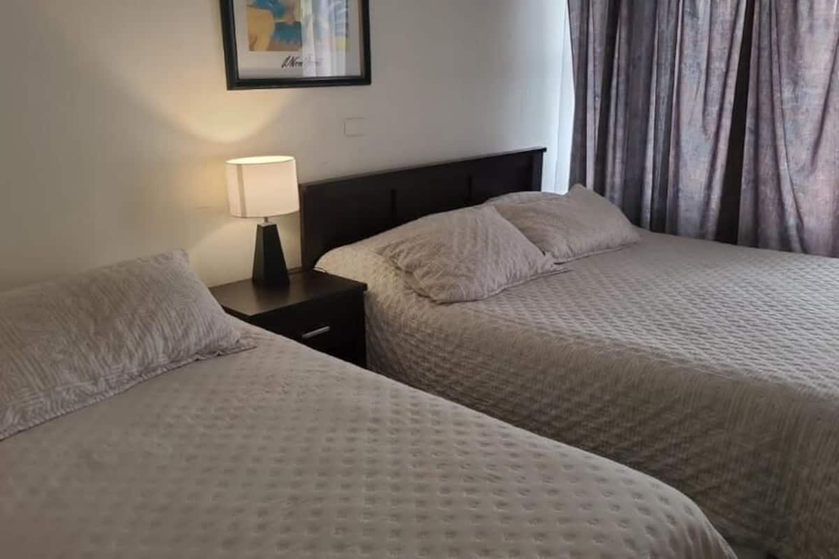 family room | premium bedding, desk, laptop workspace, iron/ironing board