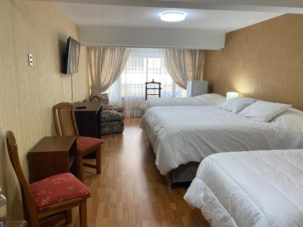 deluxe quadruple room | premium bedding, desk, laptop workspace, iron/ironing board