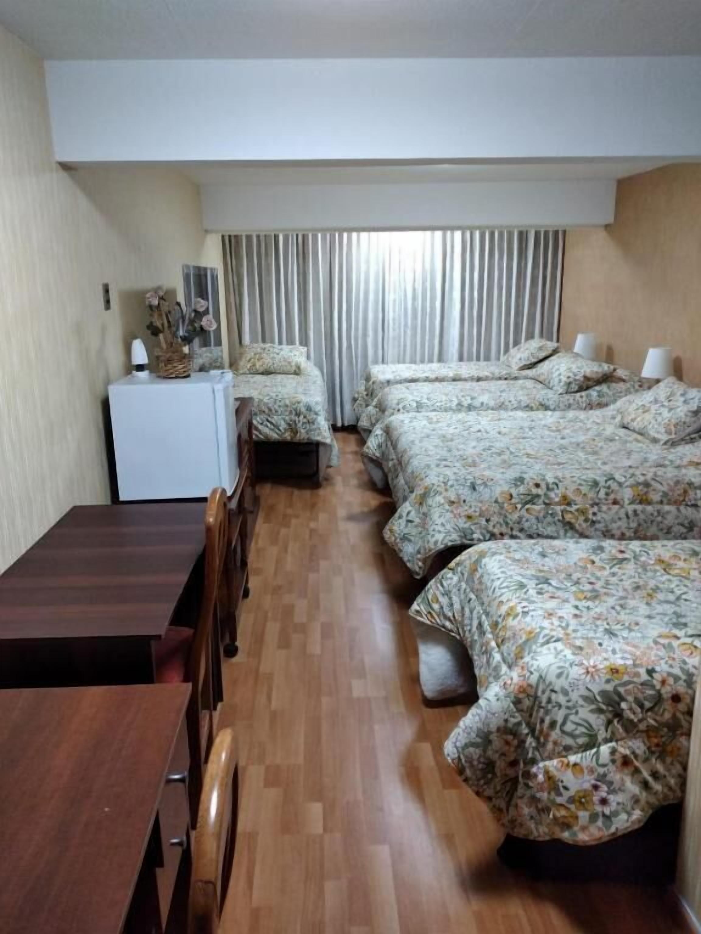 deluxe quadruple room | premium bedding, desk, laptop workspace, iron/ironing board