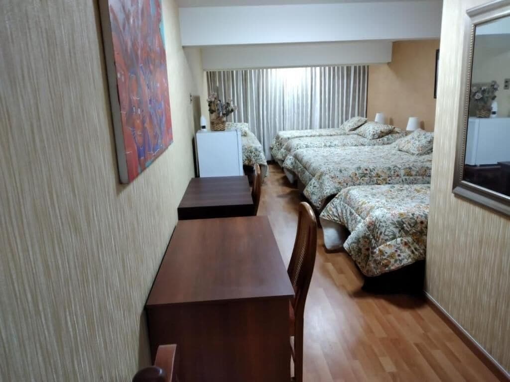 deluxe quadruple room | premium bedding, desk, laptop workspace, iron/ironing board