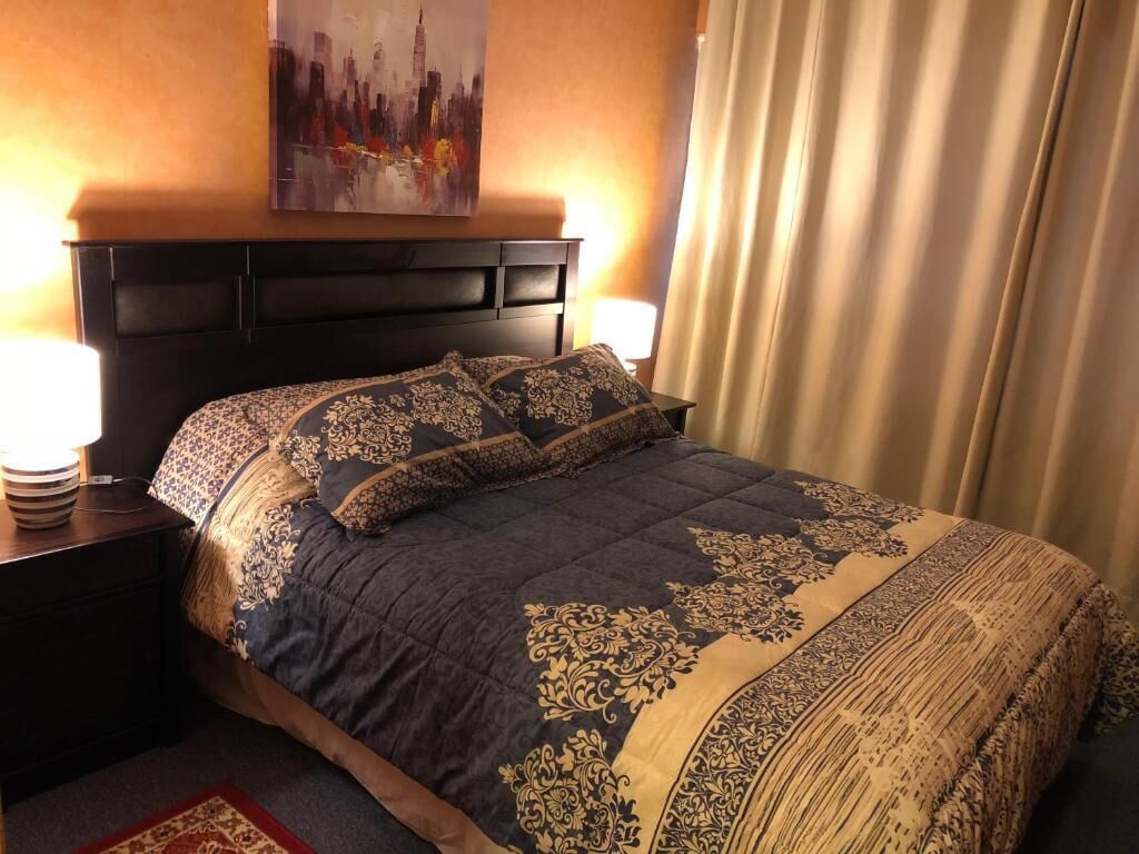 deluxe studio suite | premium bedding, desk, laptop workspace, iron/ironing board