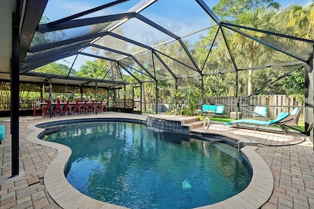 A heated pool. Poolside Cocoa Oasis with Tiki Bar