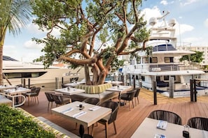 Enjoy al fresco dining with a view of the surrounding water and other yachts from this spacious outdoor dining area.