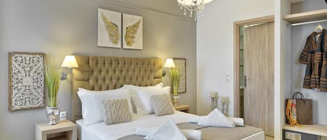 A neatly arranged bedroom with a large bed, bedside lamps, decorative wall art, and a wardrobe.