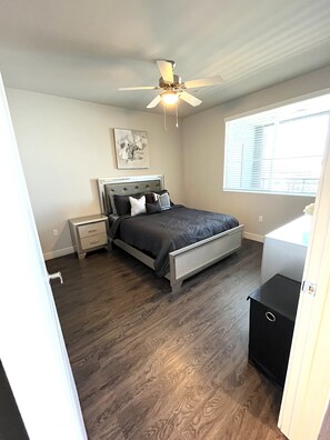 Relax in a serene bedroom with a bed, bedside tables, and a ceiling fan.
