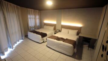 Premium Quadruple Room | Minibar, blackout drapes, free WiFi, bed sheets