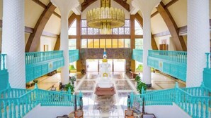 A grand lobby with a central altar, high ceilings, and a chandelier. - King Land Hotel (Mengla)