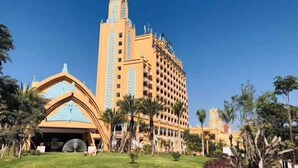 A large hotel with a central tower and a smaller building with a distinctive facade. - King Land Hotel (Mengla)