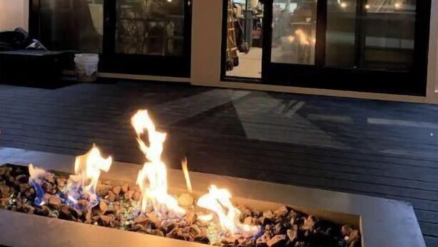 A modern building with large glass windows and a fire feature in the foreground. - High tech modern farmhouse in Franklin, NY (Franklin)