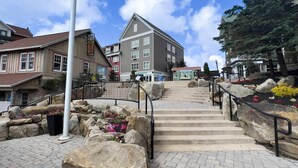 A stone staircase leading to a building with a sign 'Information' at the top. - SC 5114 | Mountain Bike HQ with Pool Access & Cozy Comforts (Snowshoe)
