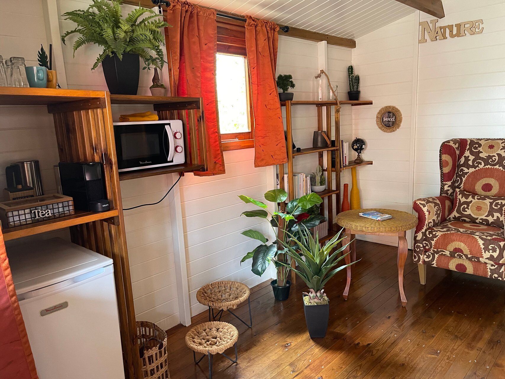 A compact living space with a kitchenette, a dining area, and a seating area.