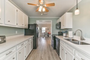 Enjoy cooking in this well-equipped kitchen with a refrigerator, microwave, and sink.