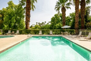 A swimming pool with lounge chairs and palm trees. - Waterfront Desert Escape, Waterfalls, Membership Access (Palm Desert)