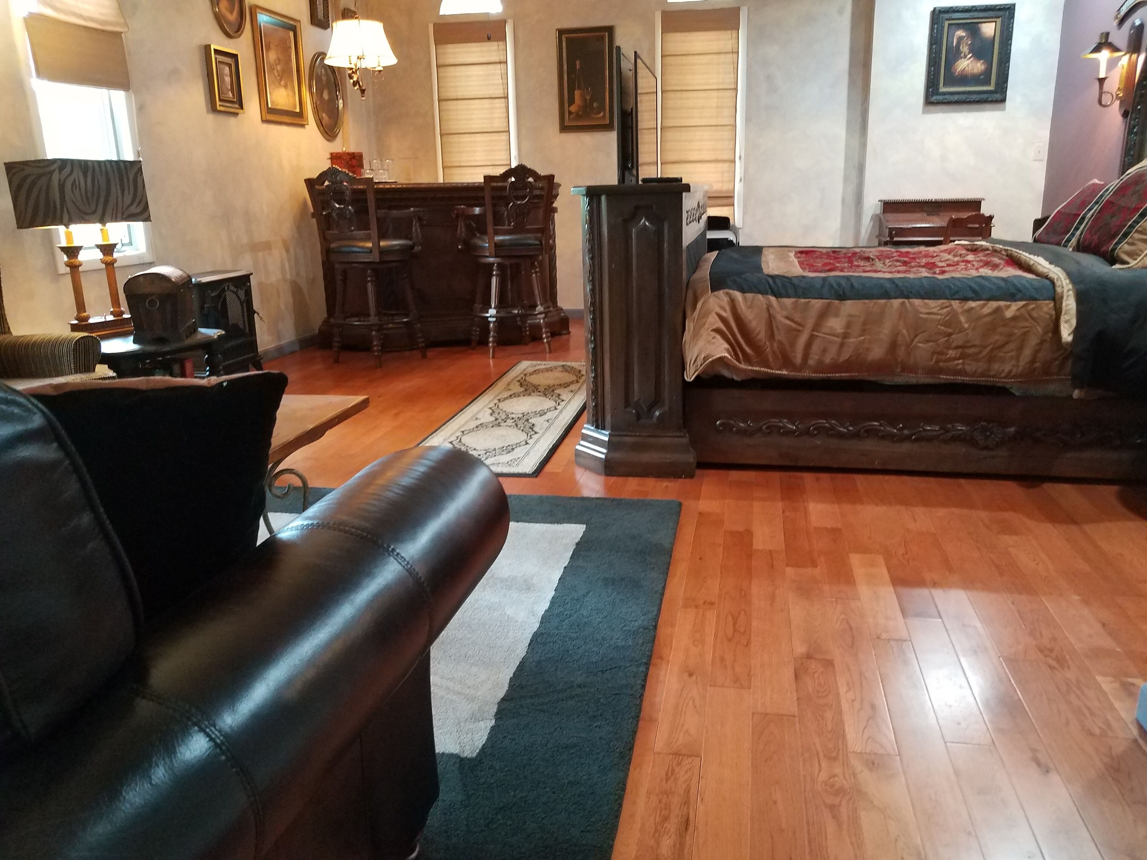A room with a bed, a desk, a chair, a lamp, and a window.