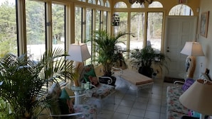 A sunlit room with arched windows, a chandelier, and a door marked "EXIT". - Tuscan Manor (Eureka Springs)