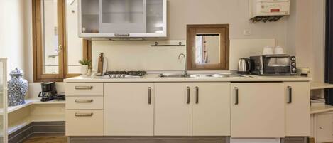 Fridge, microwave, stovetop, coffee/tea maker