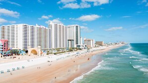 A beachfront hotel with multiple high-rise buildings, a sandy beach, and ocean views. - Modern Beach Highrise  Ocean Walk Resort 1 BR Ocean View W/Jacuzzi Daytona Beach (Daytona Beach)