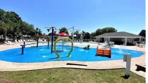 A swimming pool with a slide, a water play area, and a covered pavilion. - 3 bedroom house that sleeps 9 located in Oceanside Village, Surfside Beach (Surfside Beach)
