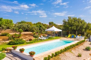 A swimming pool with lounge chairs and a white tent. - Villa Milizie, Scicli, Italy (Scicli)