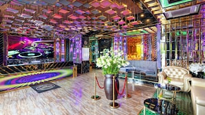 A luxurious lobby with a modern design, featuring a large screen, a seating area, and a decorative vase with flowers. - Ravatel Home Bac Giang (Bac Giang)