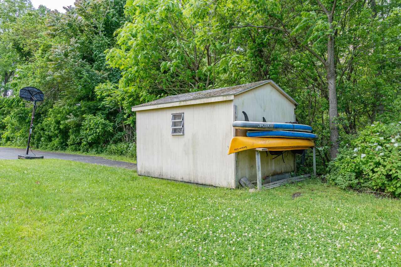 A small shed with a roof, a door, and a window.