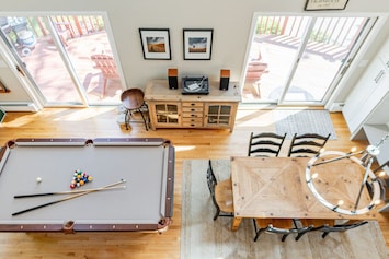 Loft view of the pool table and dining area