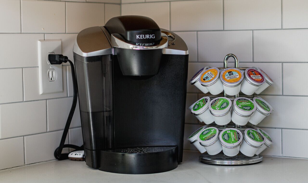 A Keurig coffee machine with a coffee pod holder containing multiple pods.