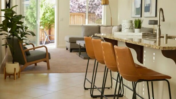 A modern kitchen with a bar area, a dining set, and a view of the outdoors. - ★NEW★ Upscale House, Tahoe 30-min w/ Cal King (Reno)