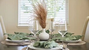 A dining table set with green napkins, white plates, and clear wine glasses. - ★NEW★ Upscale House, Tahoe 30-min w/ Cal King (Reno)