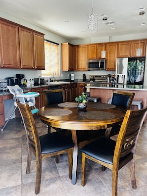 Enjoy cooking and dining in this well-equipped kitchen with a round dining table and central island.