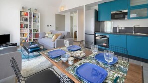A modern apartment with a dining area, kitchen, and living room. - Le Clos Moguer by Interhome (Quiberon)