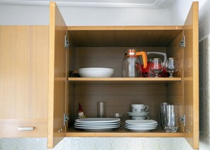 Open cabinet with ample storage space for kitchen essentials.