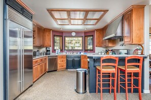 Enjoy casual dining at the central island with bar stools, featuring a stove and oven.