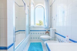 Bathtub, hair dryer, towels