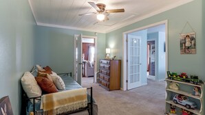 A child's bedroom with a bed, dresser, and toys.