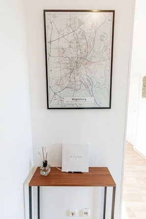 Welcome to our accommodation, featuring a framed city map of Magdeburg and a clean, minimalist design.