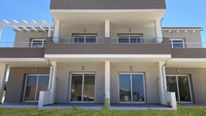 A modern two-story building with balconies, large sliding glass doors, and a flat roof. - Affittimoderni Castelsardo La Gemma (Castelsardo)