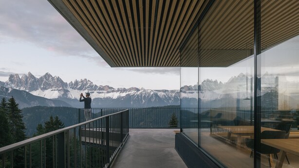 A balcony with a view of snow-capped mountains.
