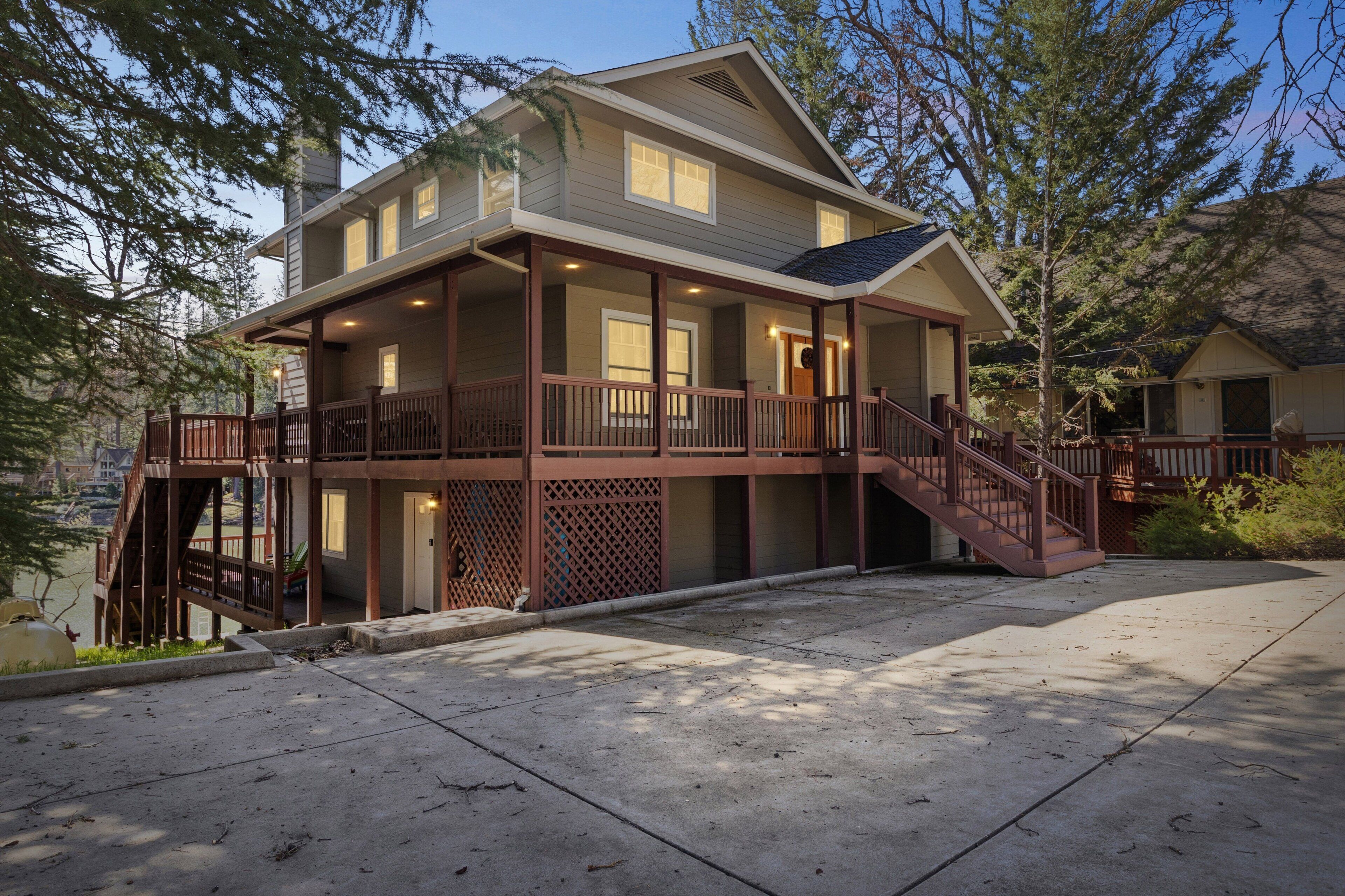 A two-story house with a covered porch and a staircase leading to the upper level.