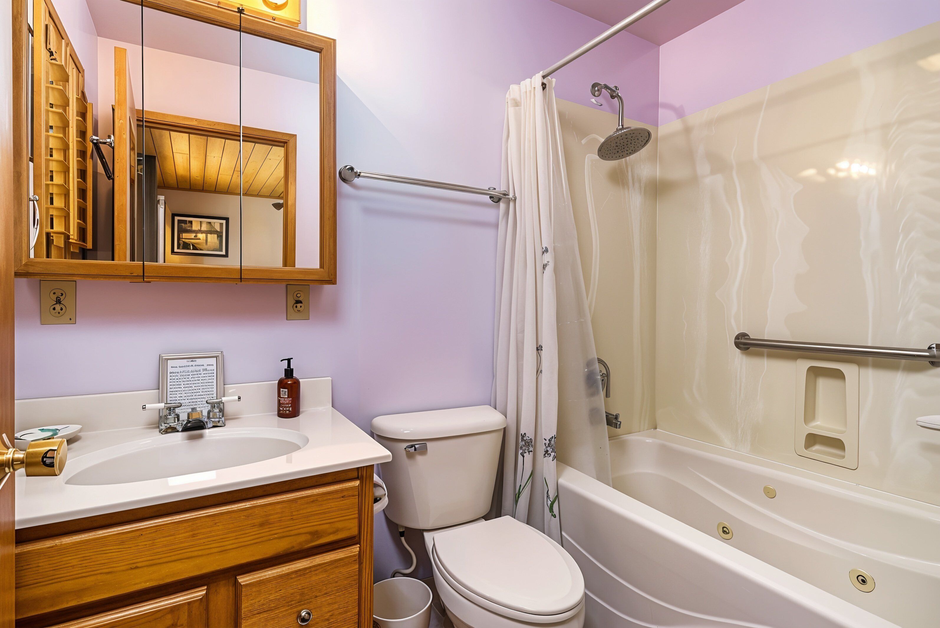 A bathroom with a sink, toilet, and bathtub.