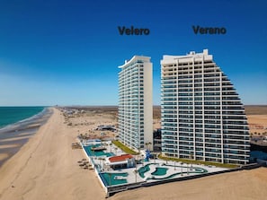 Two beachfront hotels, Veleo and Verano, offer stunning ocean views and access to a pool area with multiple pools and sun loungers.