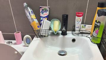 Een douche, handdoeken, zeep, shampoo