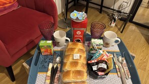 A breakfast tray with bread, condiments, and a juice box on a table. - Studio 1 min walk from Châteaubriant castle with complimentary breakfast (Châteaubriant)