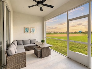 Screened Lanai with Outdoor Seating and Scenic Lawn Views