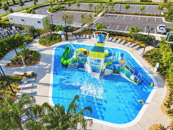 A water park with a large pool, slides, and a play structure.