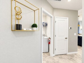 Bright Hallway with Modern Decor and In-Unit Laundry