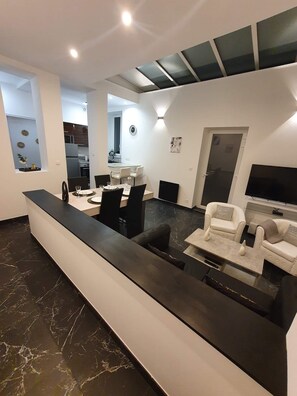 Grand Apartment | Living area | 126-cm flat-screen TV with cable channels, TV, Netflix