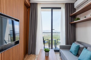 Deluxe Suite, Garden View | Living area | 51-inch LCD TV with satellite channels, TV