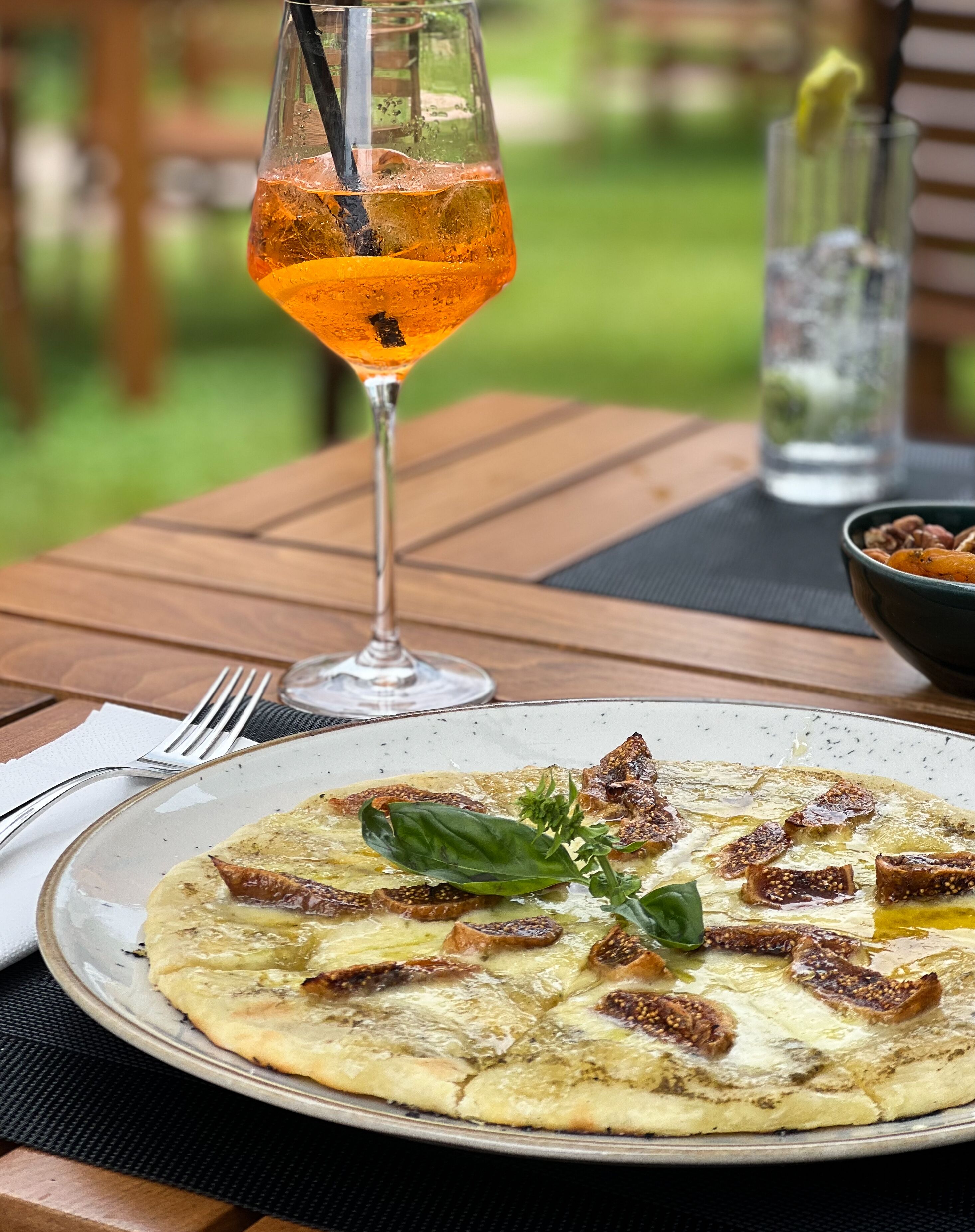 A table with a plate of food and a glass of drink.