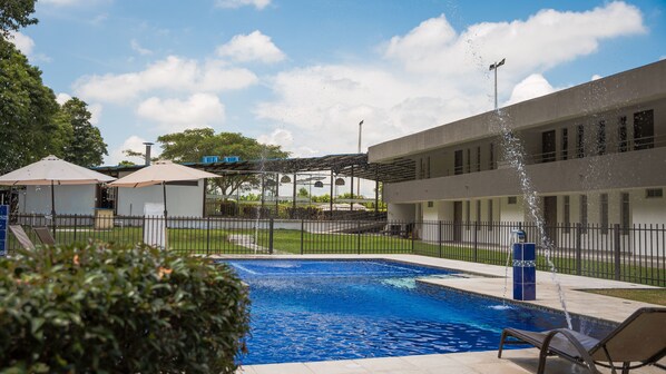 Outdoor pool, open 9:00 AM to 5:00 PM, pool umbrellas, pool loungers